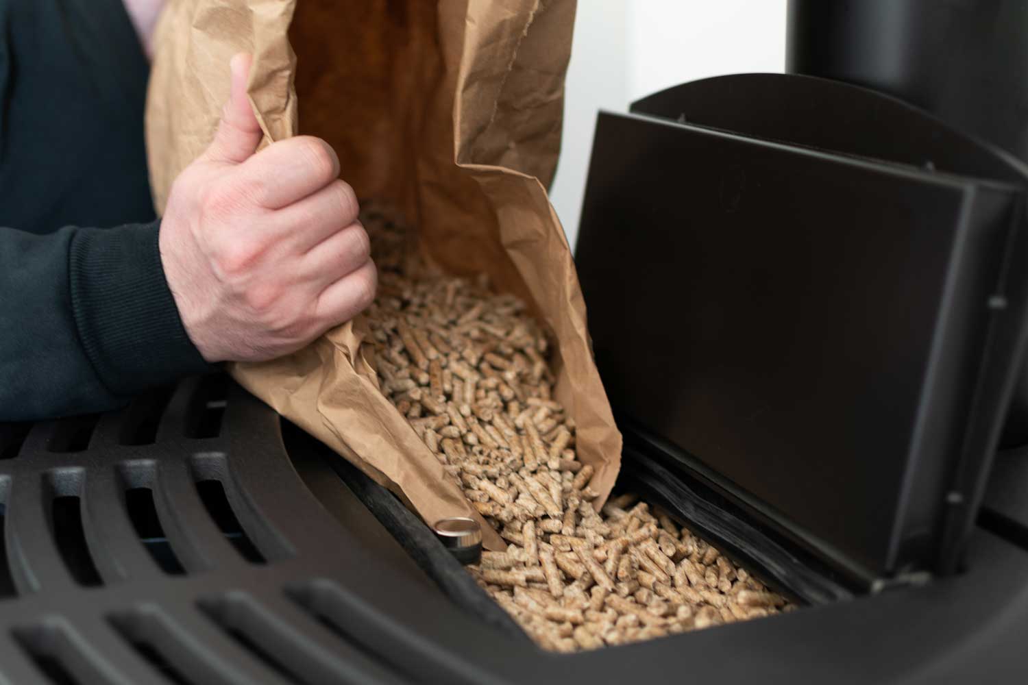 hombre-cargando-estufa-pellets-bolsa-granulos